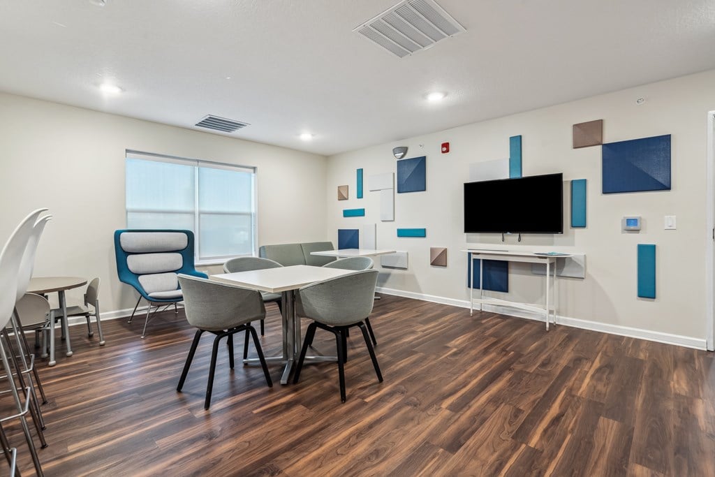 A conference room with a long table and chairs.