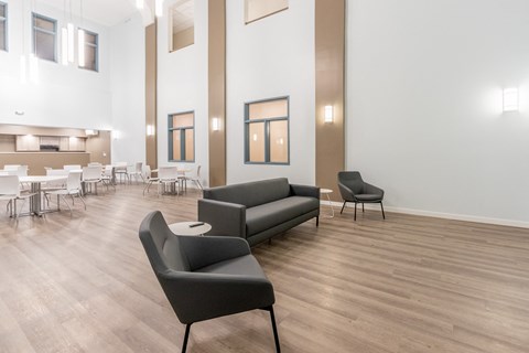 a living room with two couches and chairs and a table and chairs
