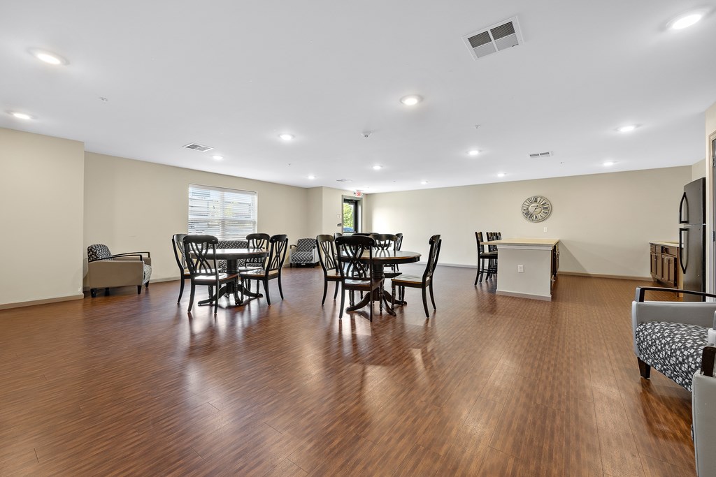 A living room with a dining table and chairs.