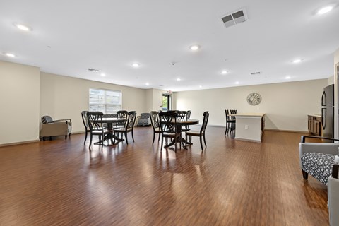 A living room with a dining table and chairs.