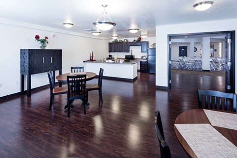 A kitchen with a dining table and chairs.
