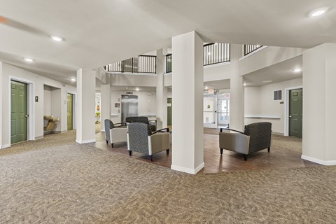 A spacious room with a carpeted floor and a balcony with a railing.