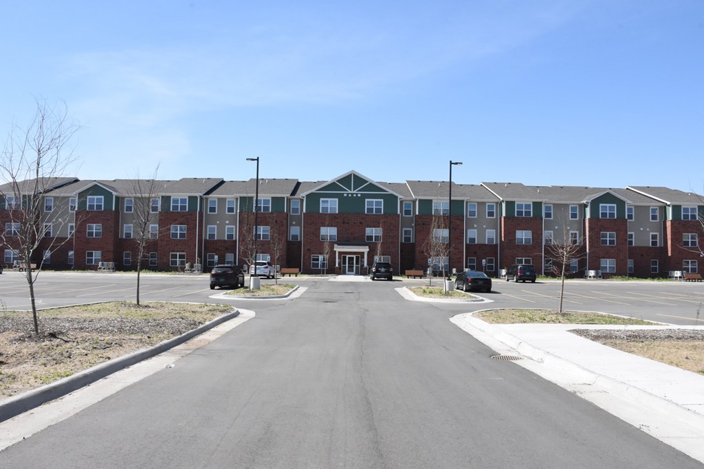A long road with apartment buildings on both sides.