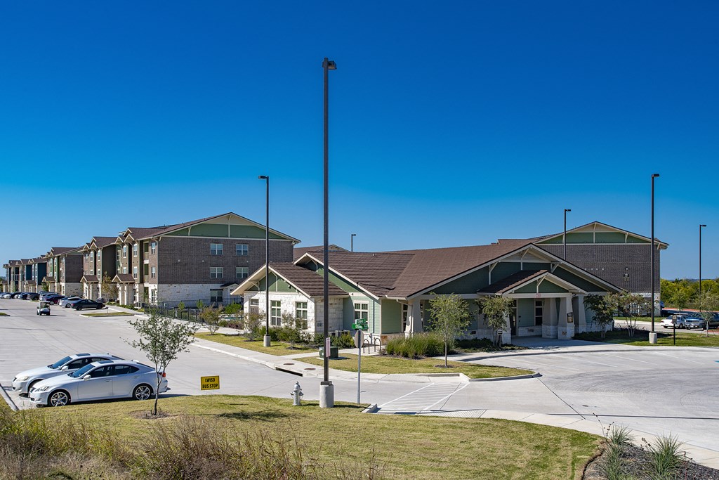a row of houses on a street with a parking lot