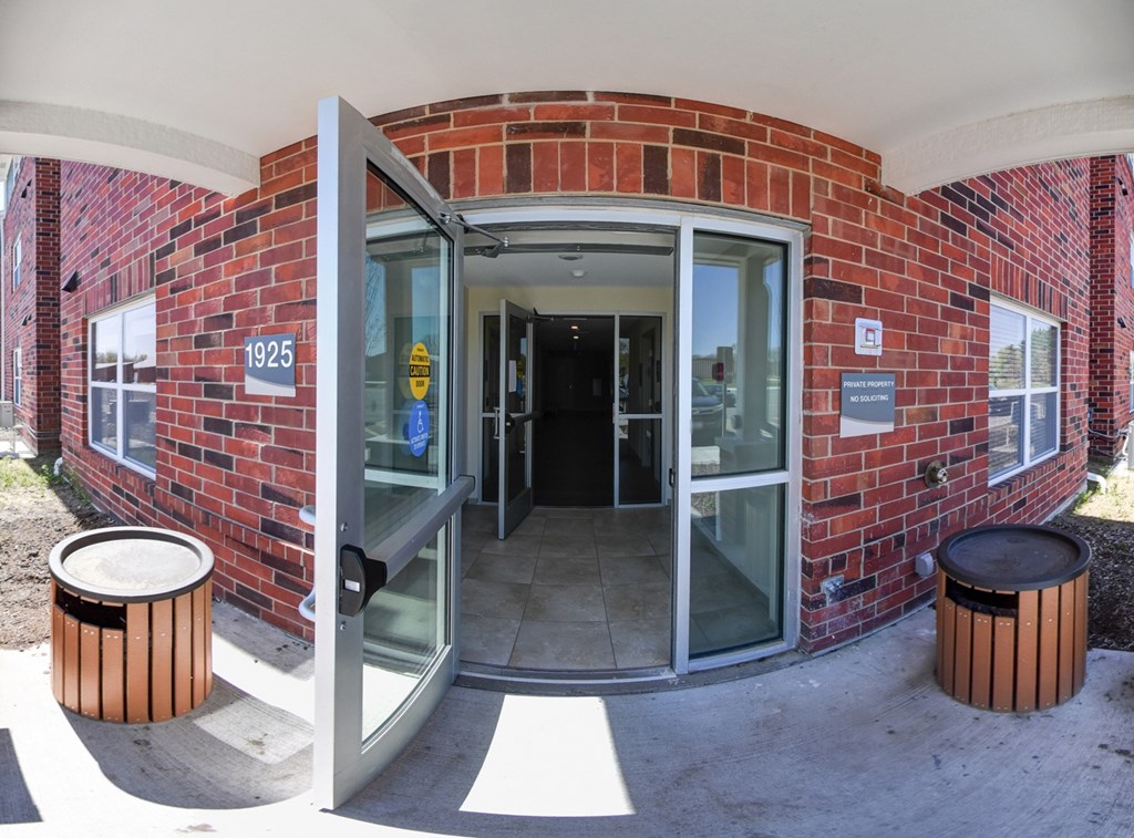 A brick building with a glass door and a sign that says 1925.