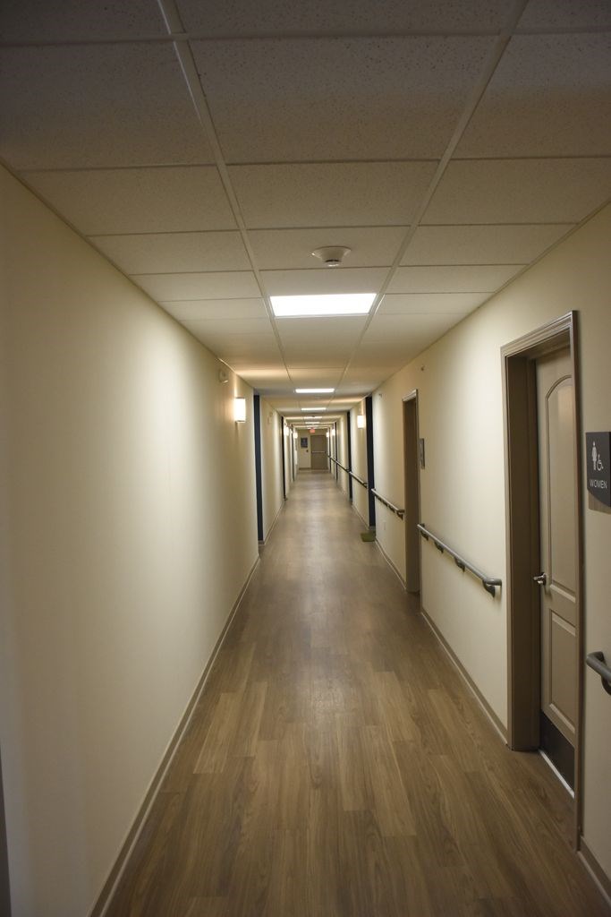 A long hallway with doors on both sides.