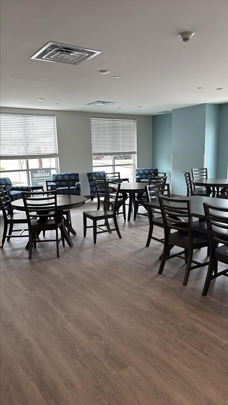 A room with wooden floors and chairs.