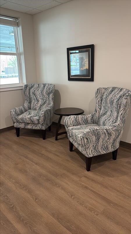 Two chairs with a small table between them.