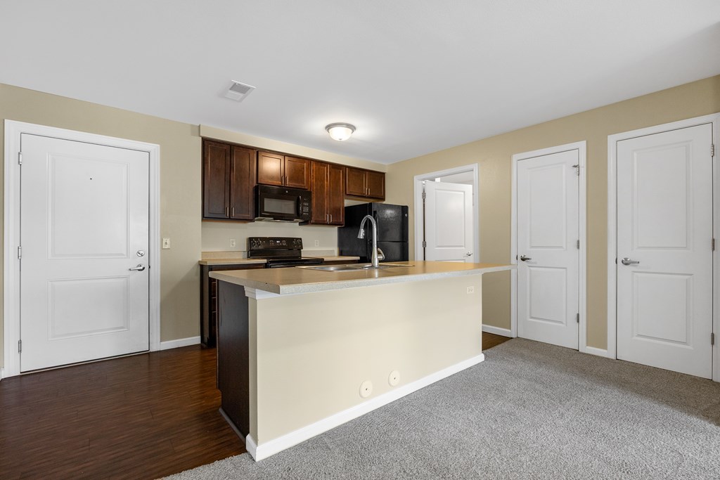 A kitchen with a white countertop and brown cabinets.