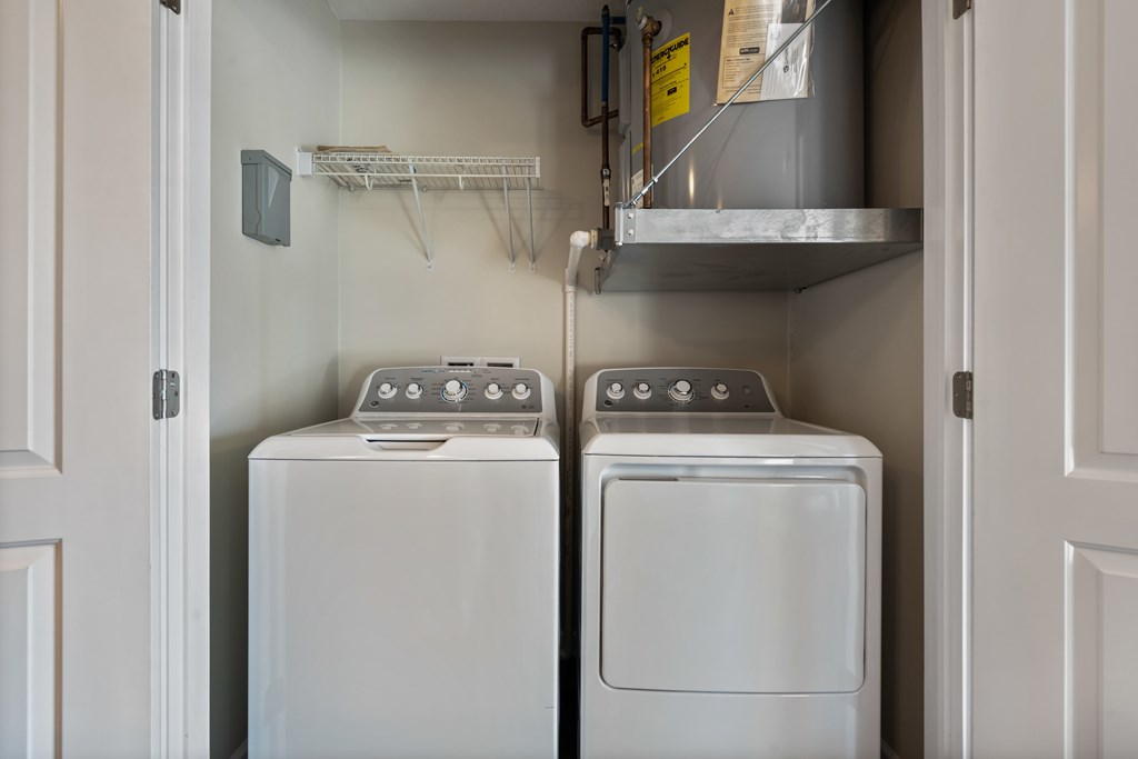 A small laundry room with a washer and dryer.
