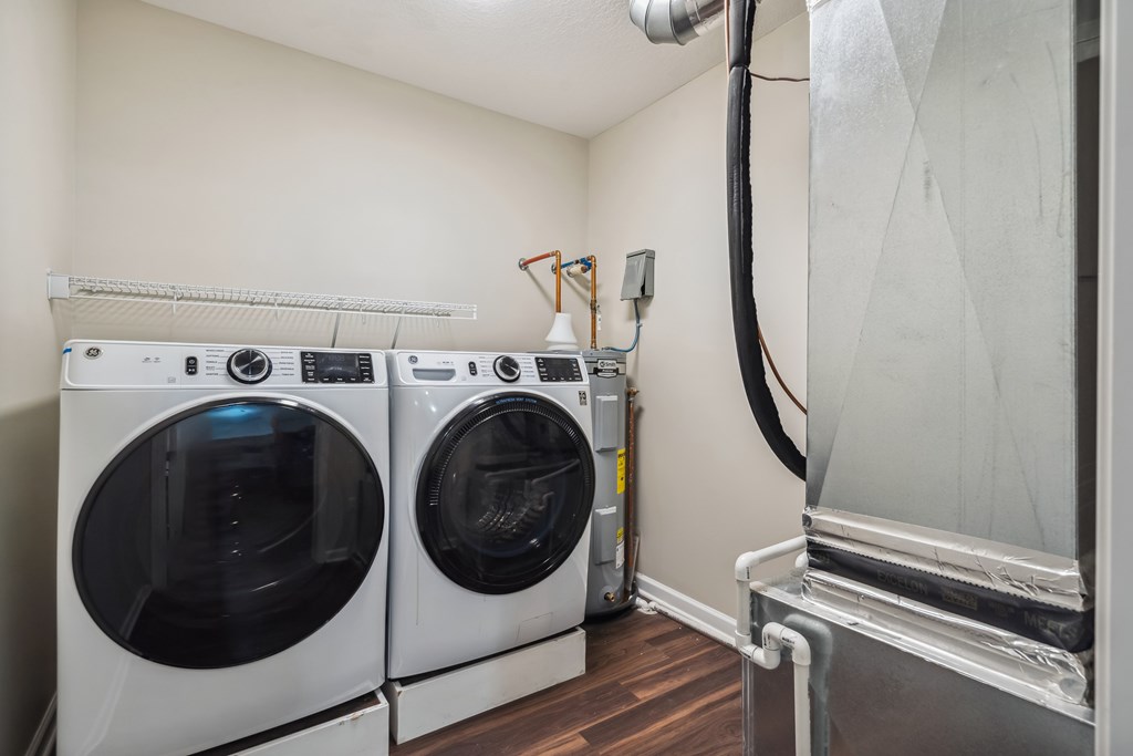 Two front loading washing machines in a laundry room.