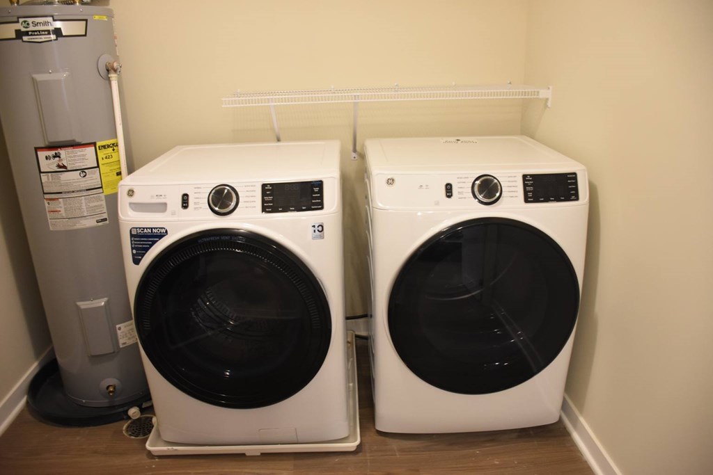 Two front load washing machines in a laundry room.