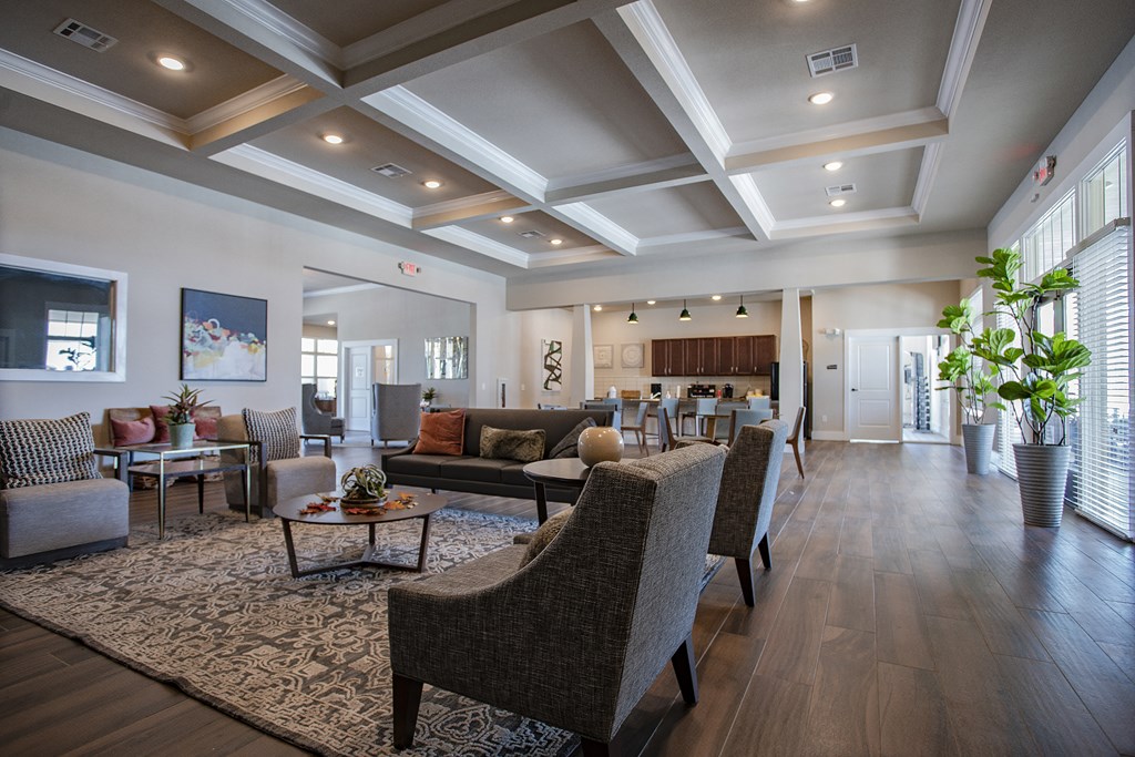 a large living room with couches and chairs and a table