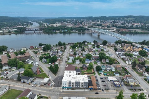 A small town with a river running through it and a bridge crossing the river.