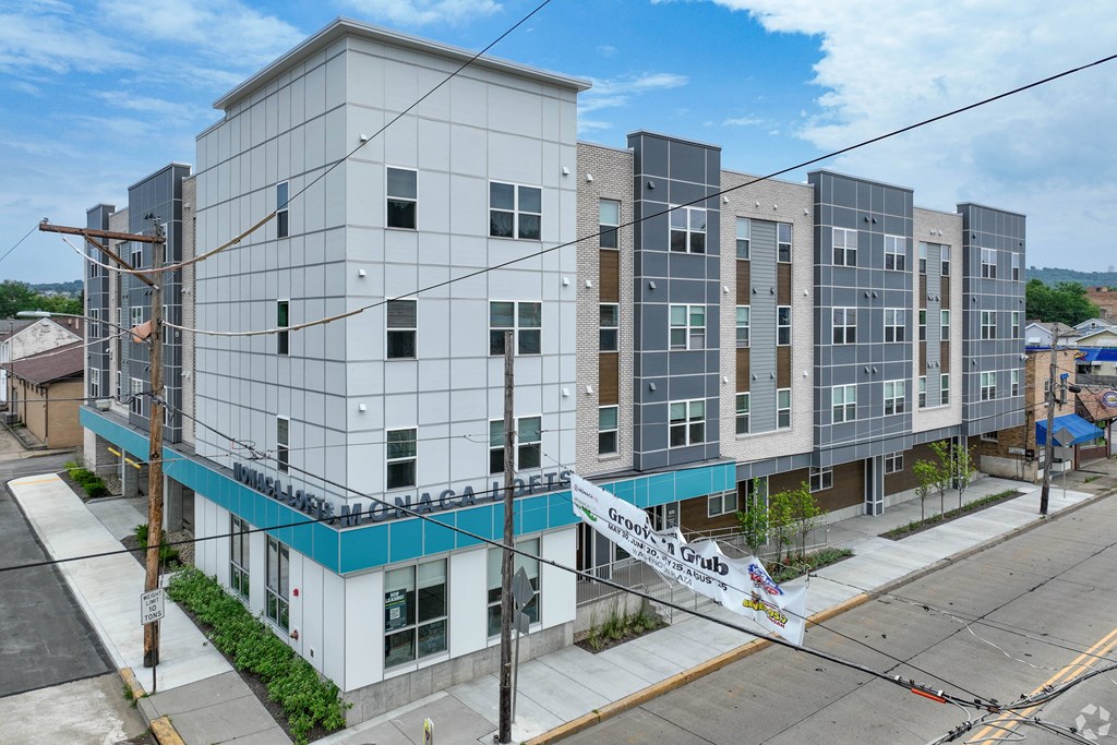 A large white building with a blue stripe on the bottom.