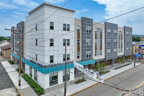 A large white building with a blue stripe on the bottom.