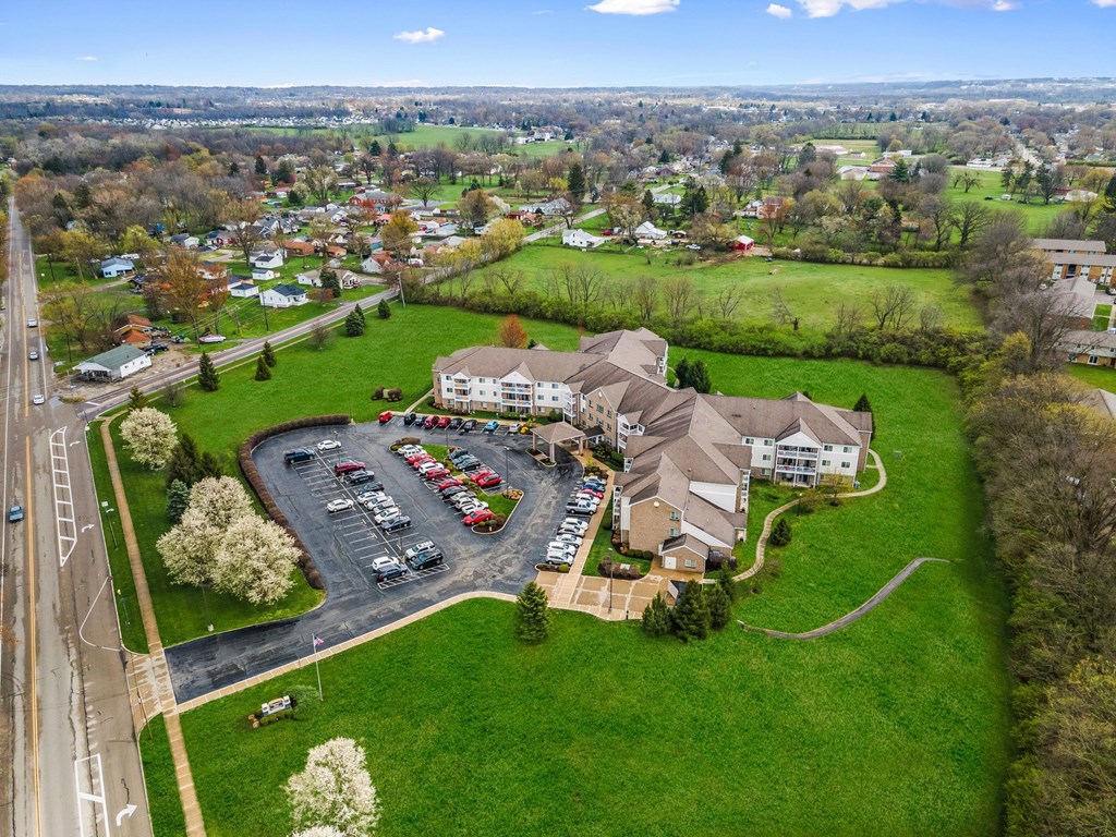A parking lot with cars and a building in the background.