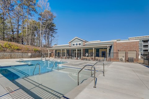 our apartments have a pool with a building in the background