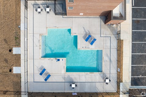 A swimming pool surrounded by a concrete floor and walls.