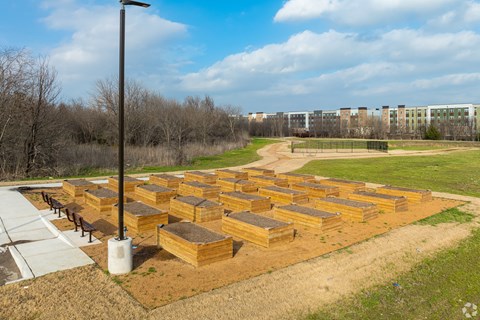 A beekeeping area with wooden hives and a street light.