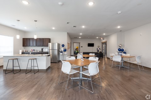 A modern kitchen with a dining table and chairs.