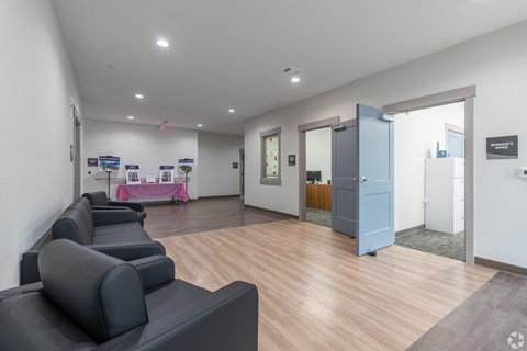 A room with a blue couch and a white wall.