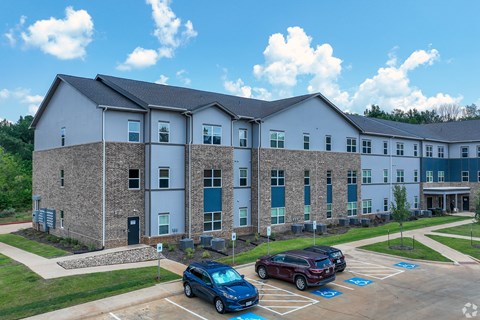 A building with a parking lot in front of it.