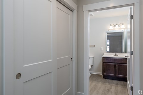 A white door with a round handle is on the left.