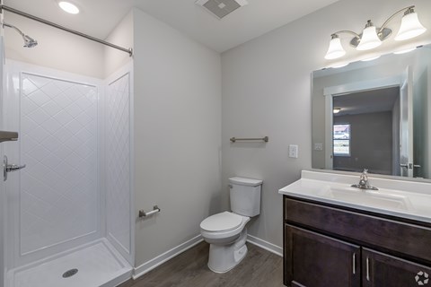 A white toilet sits next to a white sink in a bathroom.
