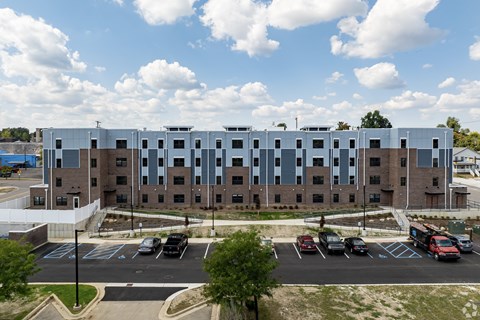 A large building with a parking lot in front of it.