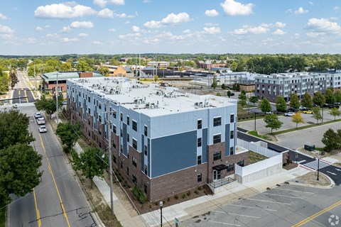 A large building with a parking lot in front of it.