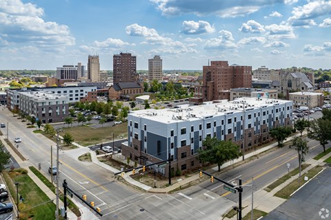A city street with a large building under construction.