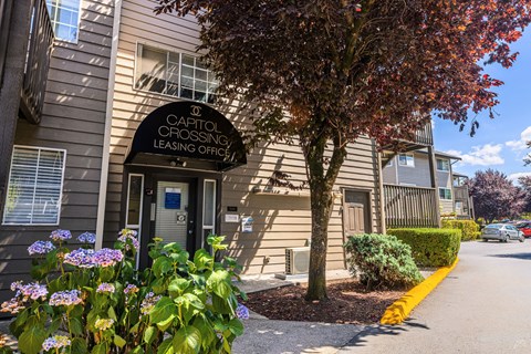 A building with a sign that says "Capitol Crossing Leasing Office".