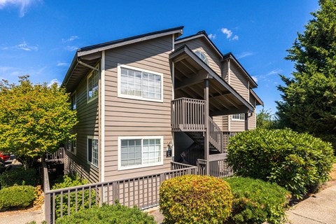 A two-story house with a balcony and a deck.