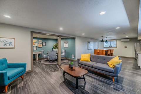 A living room with a blue couch and a wooden coffee table.