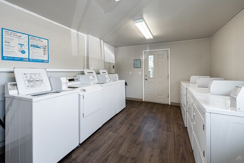 A laundry room with washers and dryers.