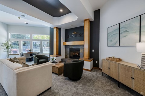 A living room with a fireplace and a painting on the wall.