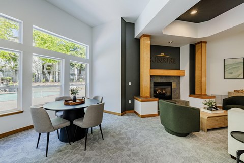 A modern dining room with a fireplace and a green armchair.