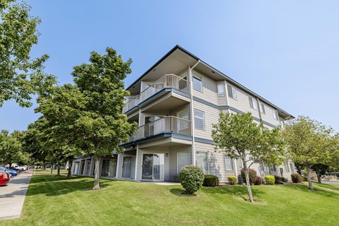 A large two-story apartment building with a balcony on the second floor.