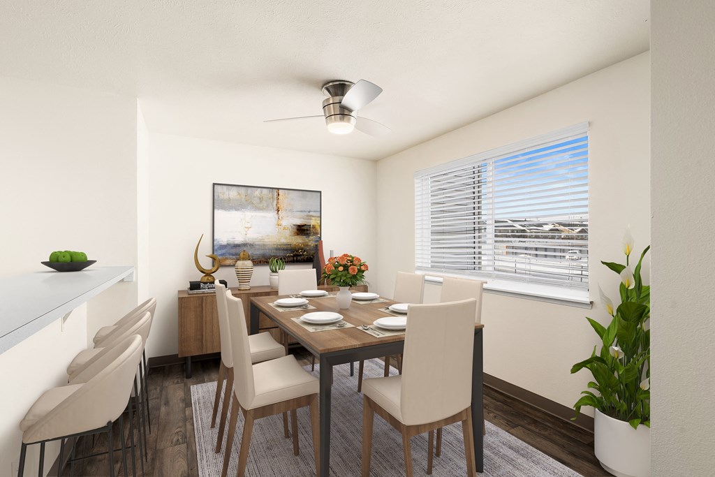 Dining Room Bright dining area with a large window on the right wall, ceiling fan, and breakfast bar to the left. Staged with a dining table, chairs, plants, and art.at Clearwater, Idaho