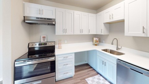 A kitchen with white cabinets and a black stove top oven.