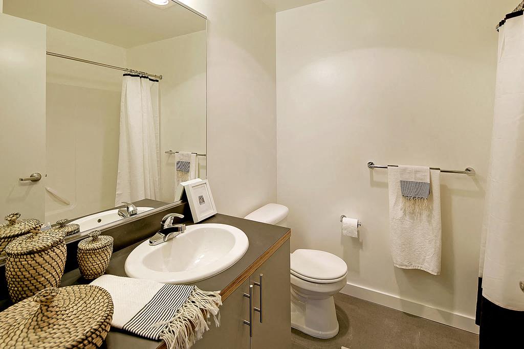 Bathroom with vanity and sink, toilet, and bath/shower combination.at 19th & Mercer, Seattle Washington