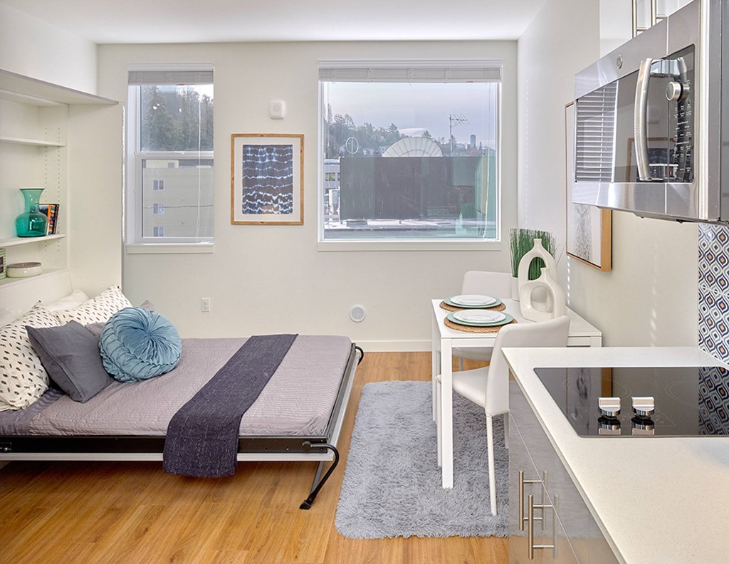 a bedroom with a bed and a desk and a window at Enve, Seattle, WA, 98102