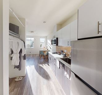 a kitchen with stainless steel appliances and white cabinets