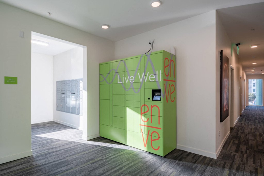 a green wall with live well written on it in a room at Enve, Seattle