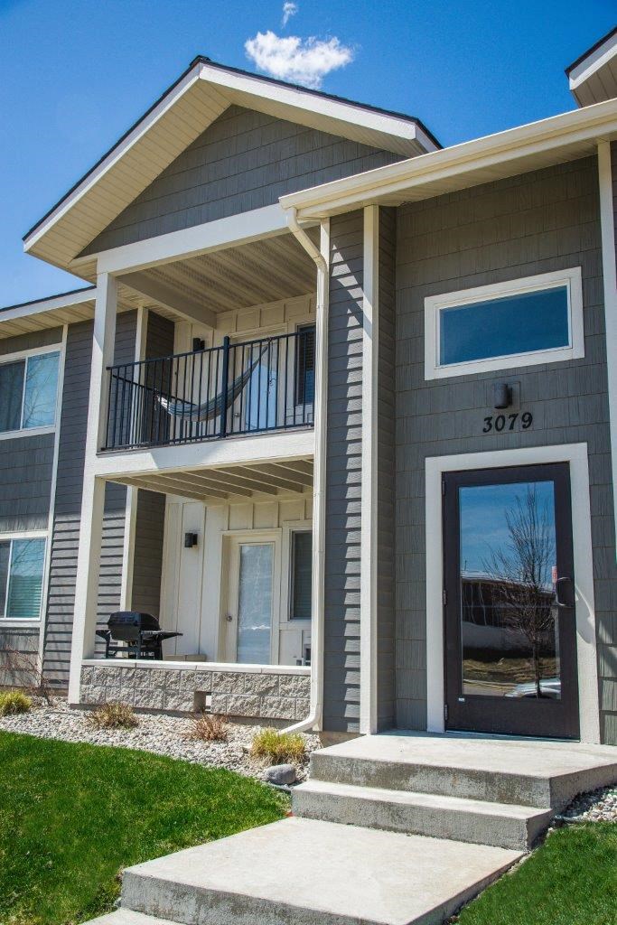 a gray house with a front porch and a glass door at Madison Park, Montana, 59718