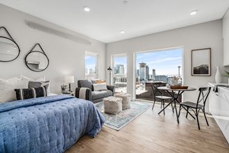 a bedroom with a large bed and a view of the city