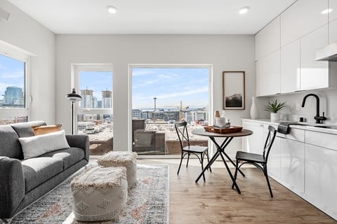 a living room and kitchen with a view of the city  at Oslo, Seattle, 98102