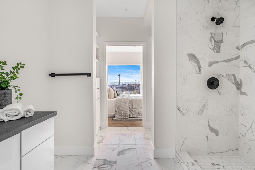 a bathroom with a view of a bed and a door to a bedroom  at Oslo, Seattle, WA