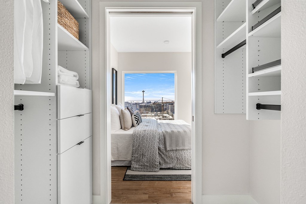 a walk in closet with a bed and a city view  at Oslo, Seattle, Washington